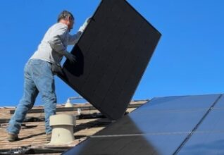 Sussex Solar Installers fitting solar panels to a roof